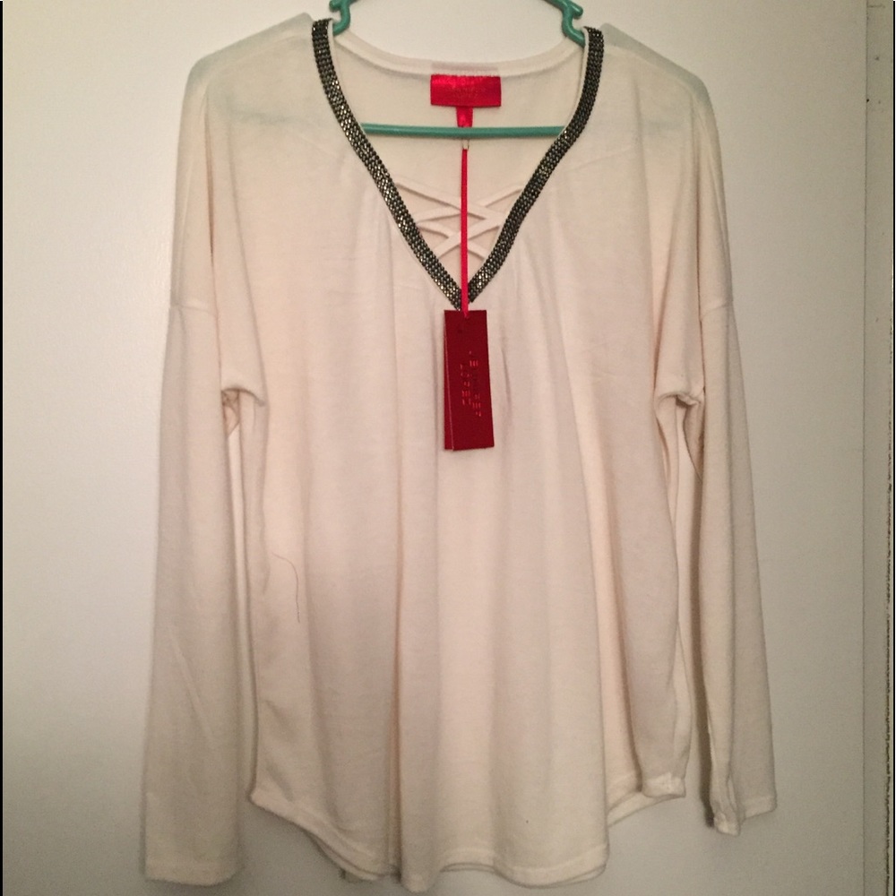 Jennifer Lopez v-neck studded/crisscross sweater.